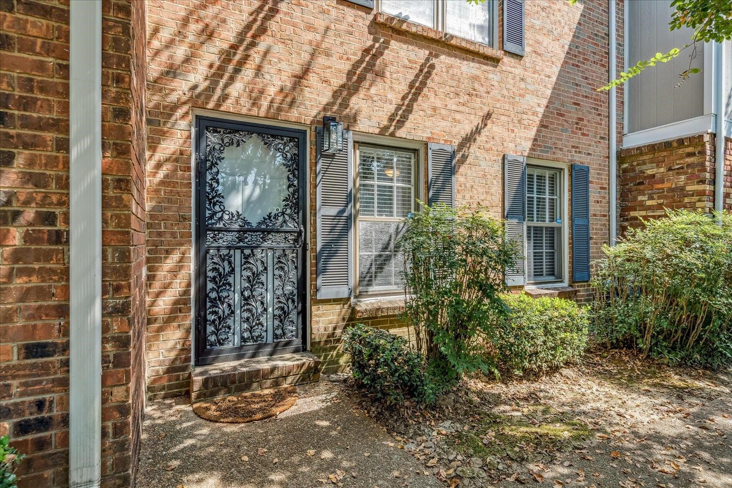 6976 Country Road, Unit 34 Germantown, TN 38138 - Photo 24 of 25 front view of a house with potted plants