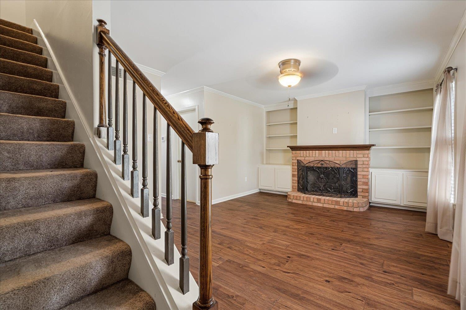 6976 Country Road, Unit 34 Germantown, TN 38138 - Photo 3 of 25 a view of a livingroom with wooden floor staircase and a kitchen