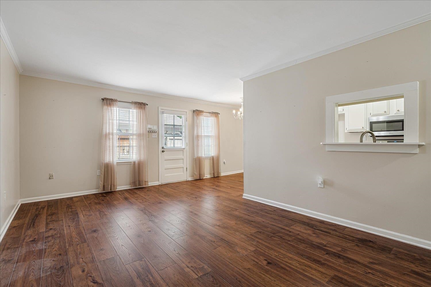 6976 Country Road, Unit 34 Germantown, TN 38138 - Photo 7 of 25 a view of an empty room with wooden floor and a window