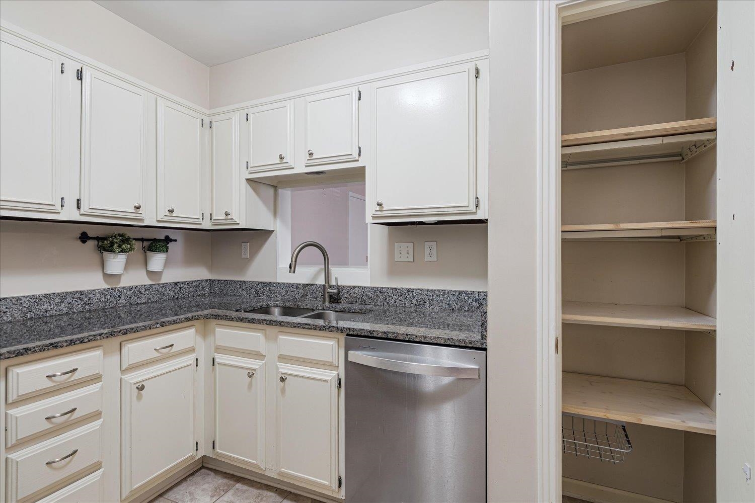 6976 Country Road, Unit 34 Germantown, TN 38138 - Photo 9 of 25 a kitchen with granite countertop a sink and cabinets