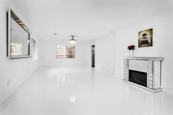 a view of an empty room with a fireplace