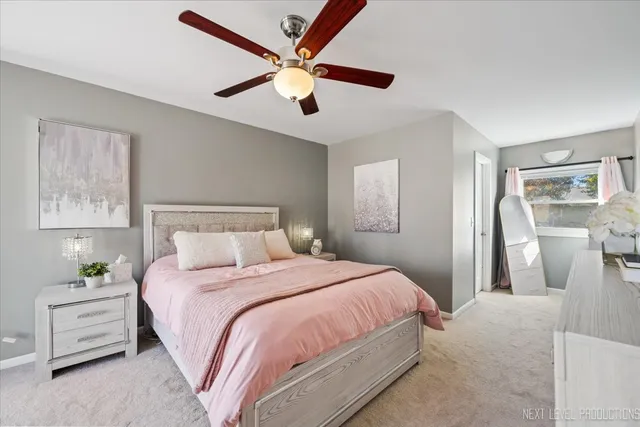 a bedroom with a large bed and a chandelier