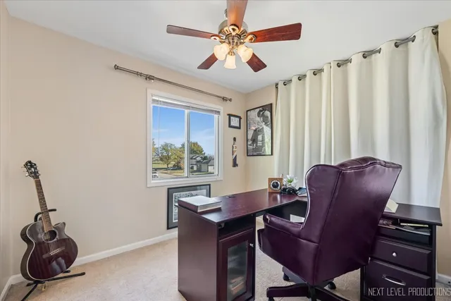 a view of a workspace with furniture and a window