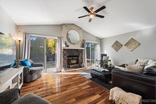 a living room with furniture fireplace and a large window