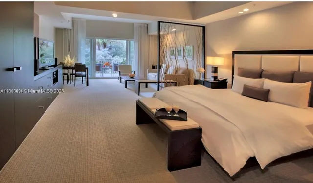 a living room with furniture a large window and a chandelier