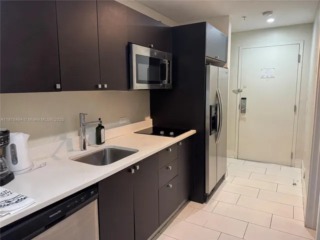 a kitchen with a sink and refrigerator