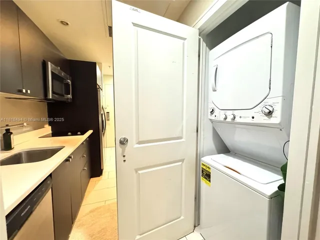 a kitchen with a sink and a refrigerator