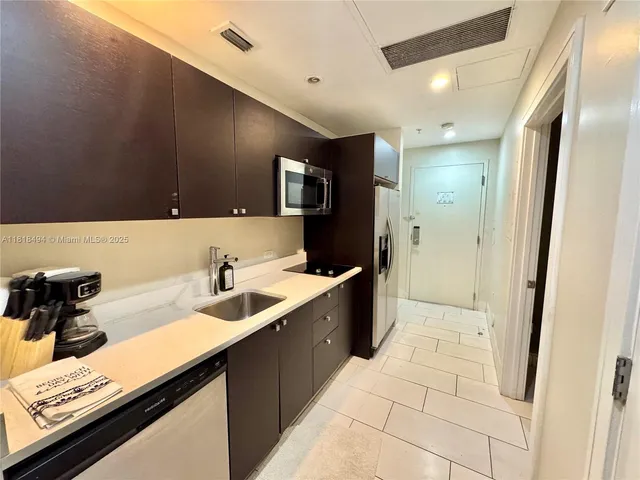 a kitchen with a sink and a refrigerator