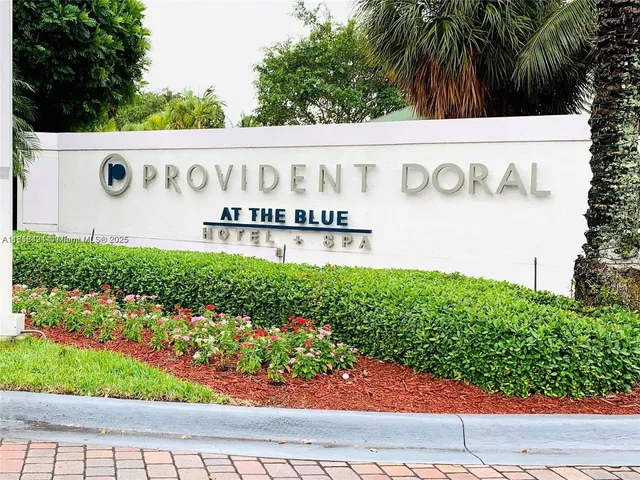 a living room with furniture a wooden floor and a chandelier