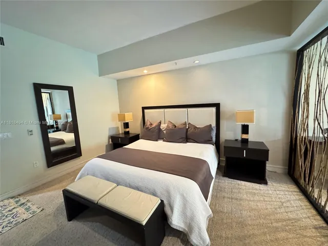 a bedroom with a bed and a mirror