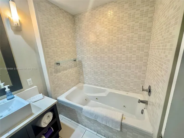 a bathroom with a bathtub and a sink