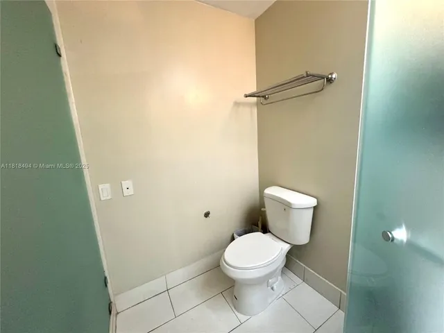 a white toilet sitting next to a bathroom sink