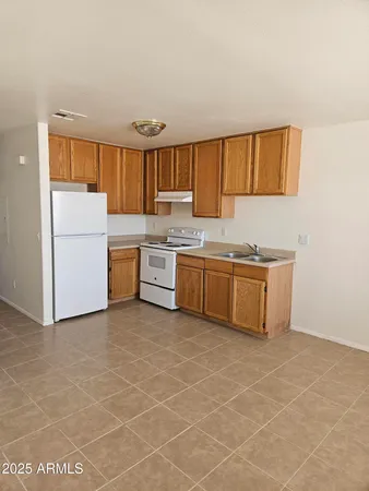 a kitchen with a cabinets and white appliances