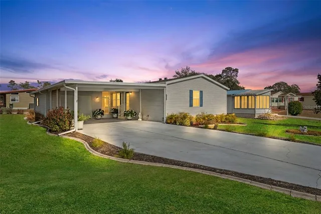 a front view of a house with a garden and yard