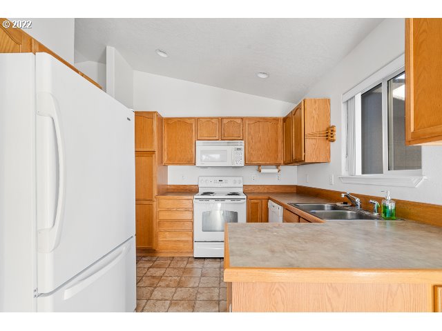 335 Jason Avenue Stanfield, OR 97875 - Photo 8 of 28 a kitchen with stainless steel appliances granite countertop a sink refrigerator and microwave