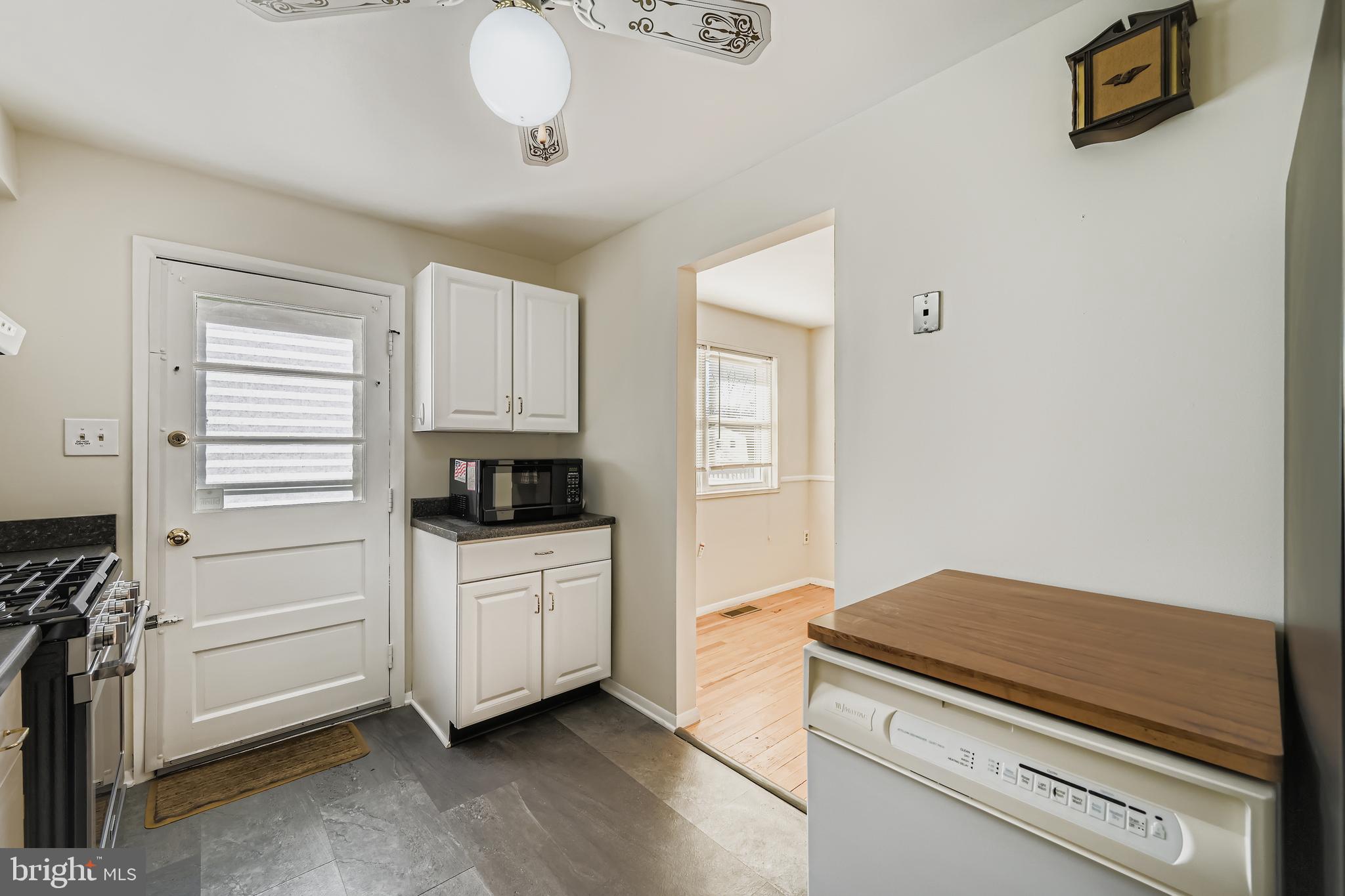 658 Kingston Road Baltimore, MD 21220 - Photo 11 of 28 a kitchen with a stove and white cabinets