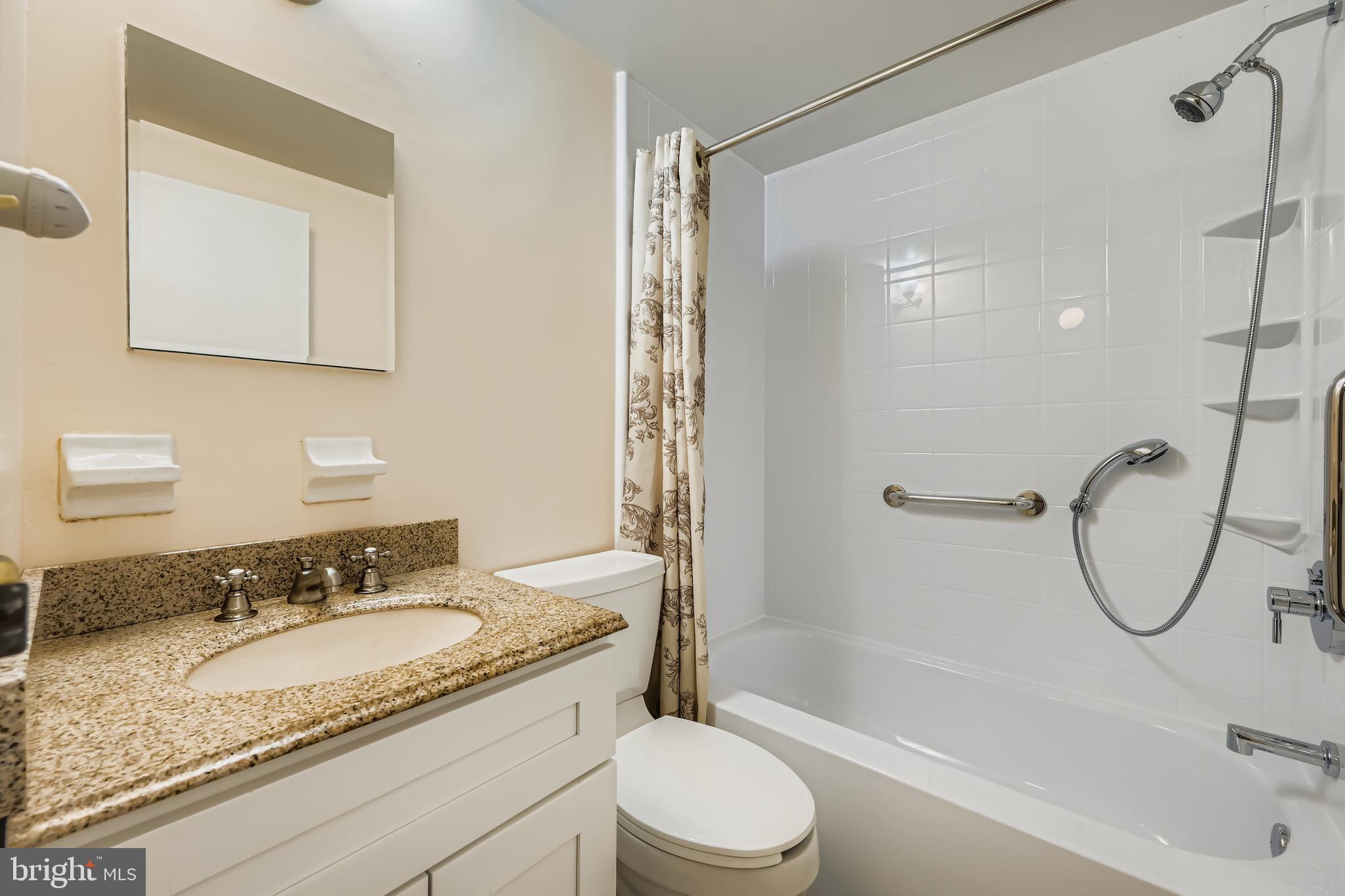 658 Kingston Road Baltimore, MD 21220 - Photo 17 of 28 a bathroom with a granite countertop sink a toilet and shower