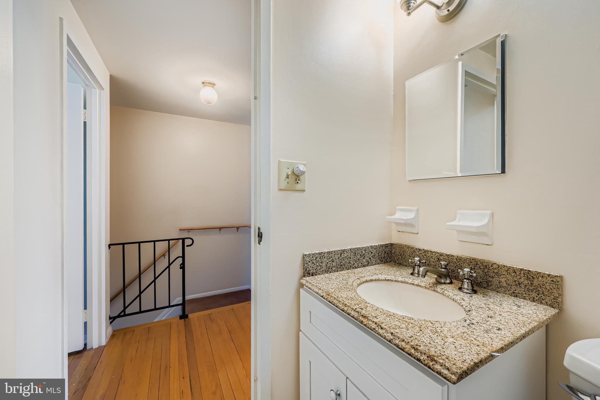658 Kingston Road Baltimore, MD 21220 - Photo 18 of 28 a bathroom with a sink and a mirror
