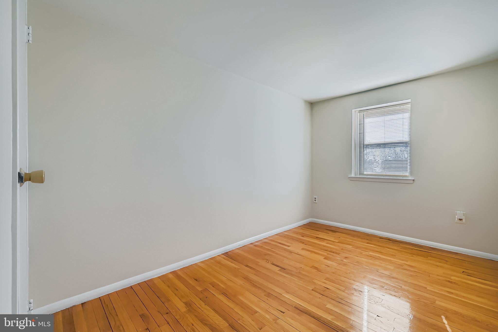 658 Kingston Road Baltimore, MD 21220 - Photo 19 of 28 a view of empty room with wooden floor