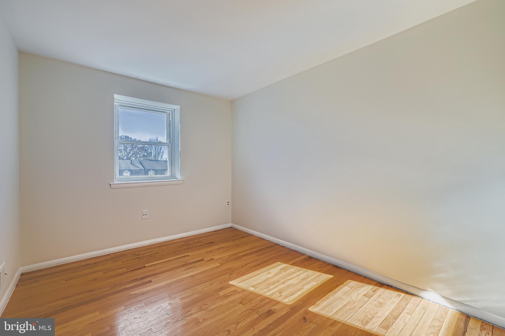 658 Kingston Road Baltimore, MD 21220 - Photo 21 of 28 a view of an empty room with wooden floor