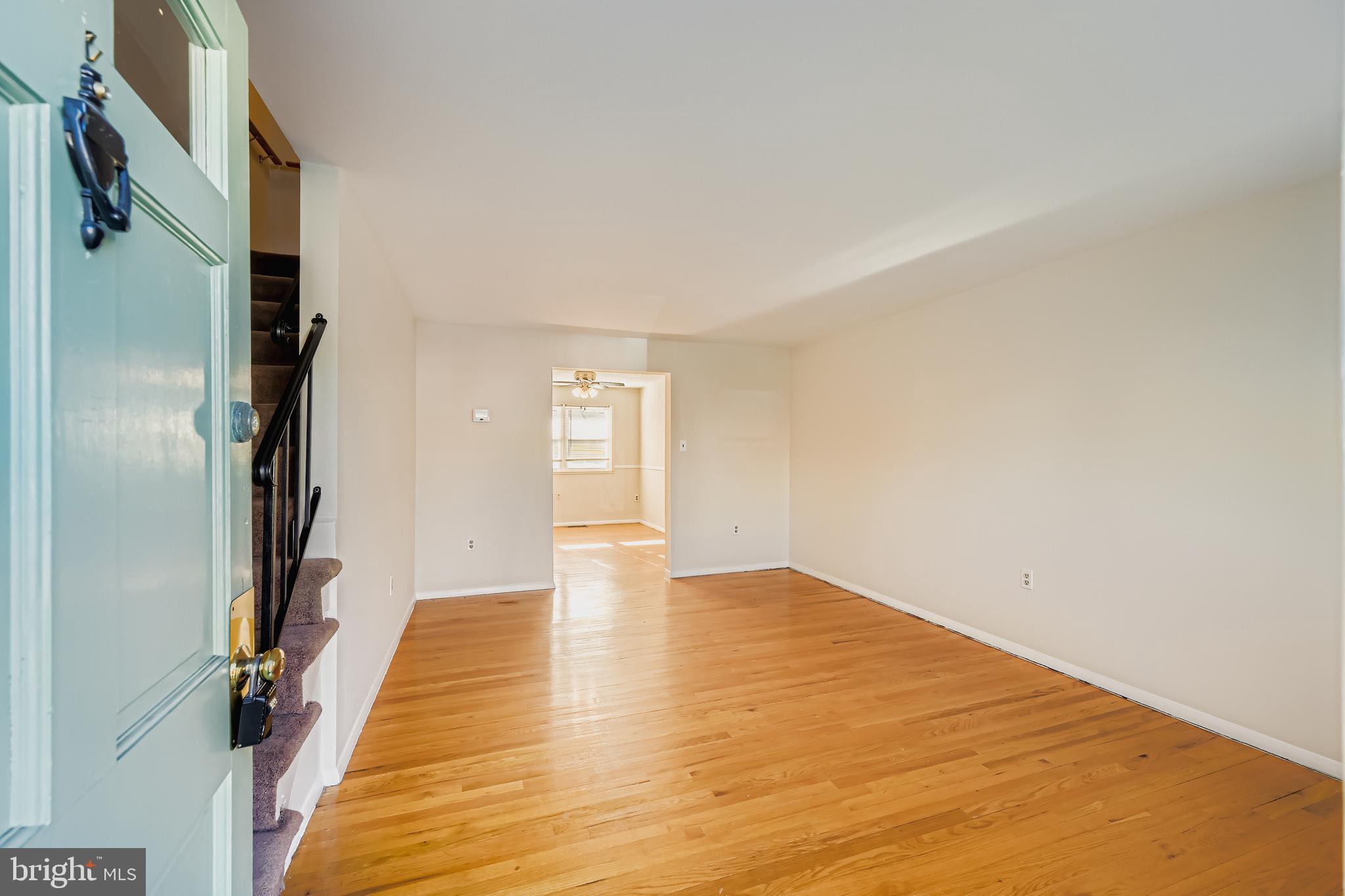 658 Kingston Road Baltimore, MD 21220 - Photo 5 of 28 a view of empty room with wooden floor and fan
