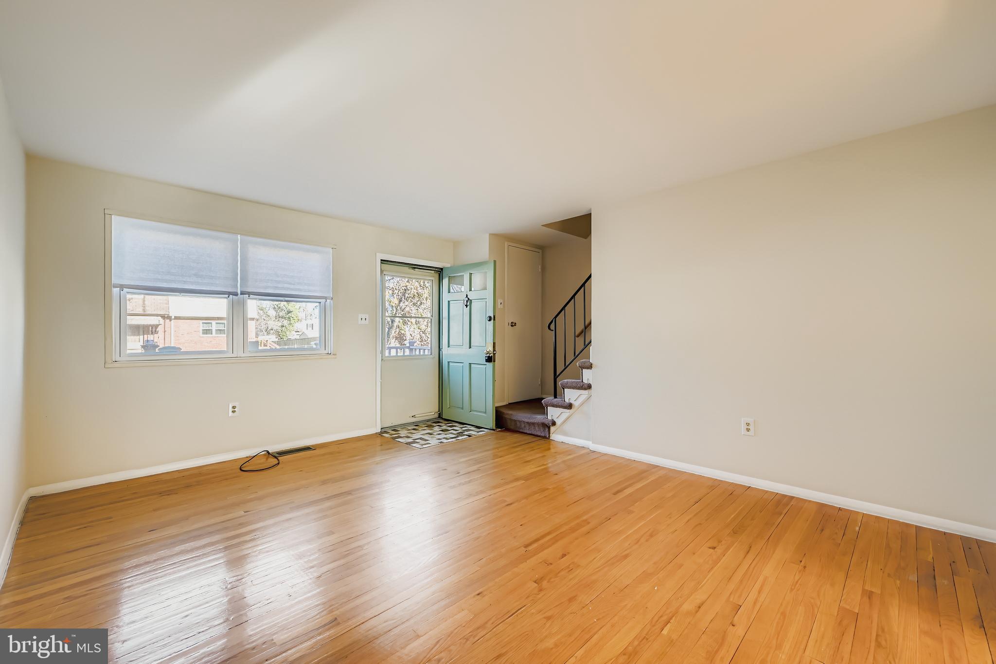 658 Kingston Road Baltimore, MD 21220 - Photo 6 of 28 an empty room with wooden floor and windows