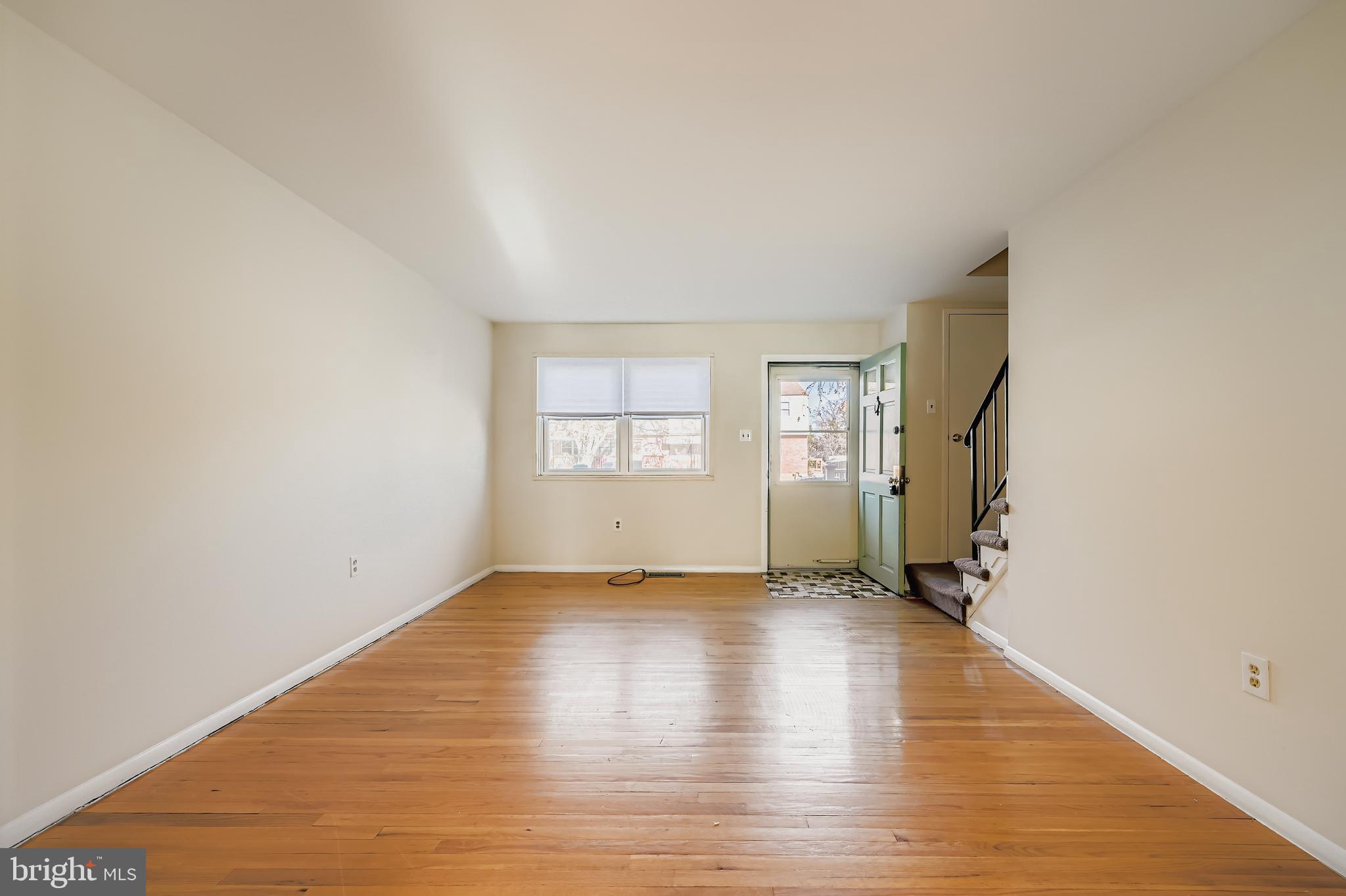 658 Kingston Road Baltimore, MD 21220 - Photo 7 of 28 an empty room with window and wooden floor