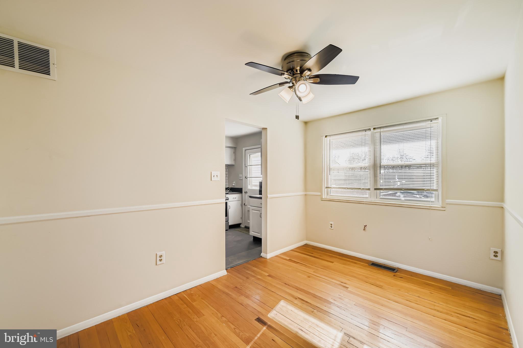 658 Kingston Road Baltimore, MD 21220 - Photo 9 of 28 a view of a room with a window and wooden floor