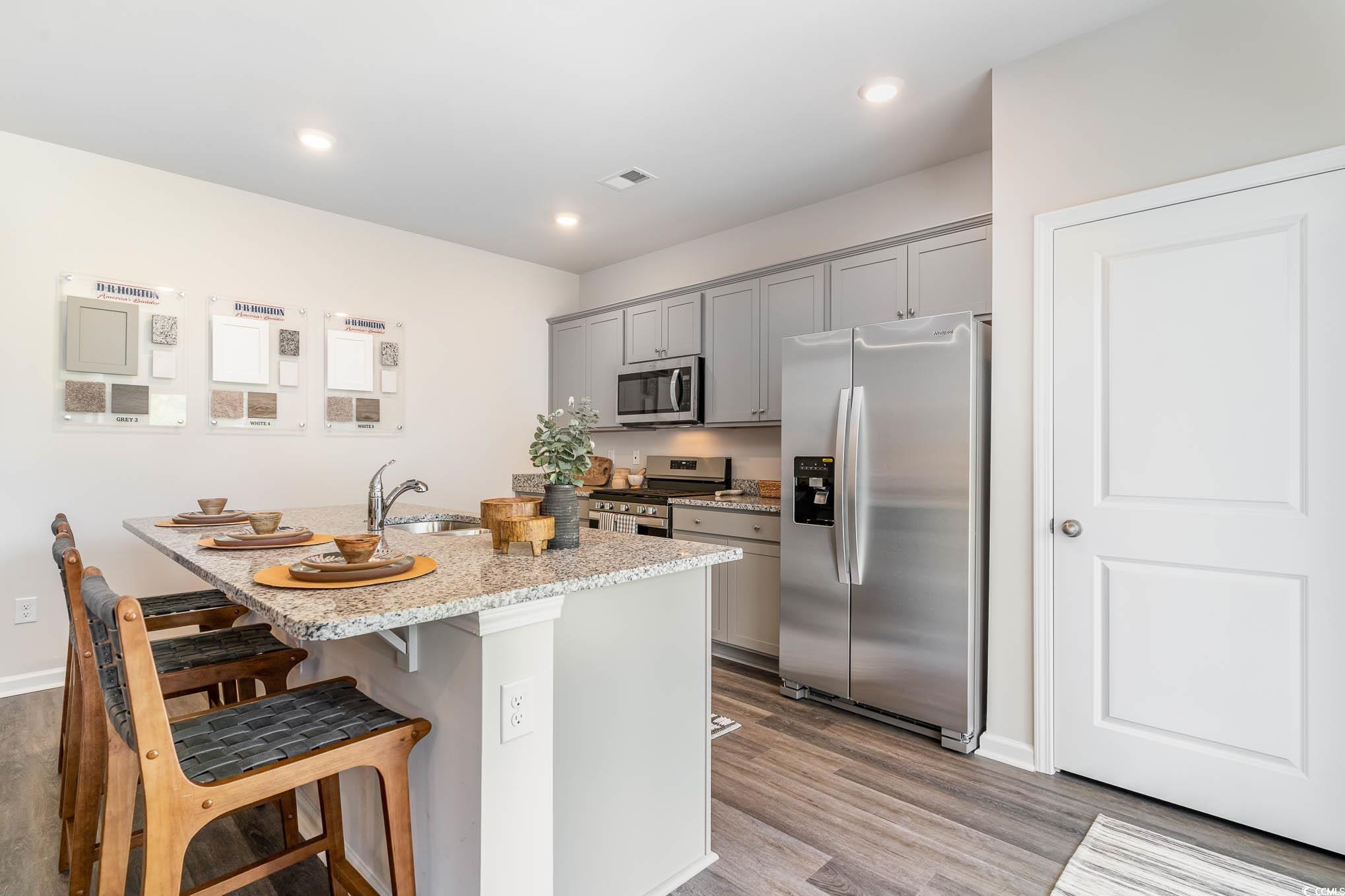 152 Pampa Drive Loris, SC 29569 - Photo 5 of 19 Kitchen featuring gray cabinets, wood finished flo