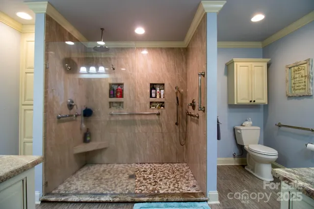 a kitchen with stainless steel appliances granite countertop a stove and cabinets