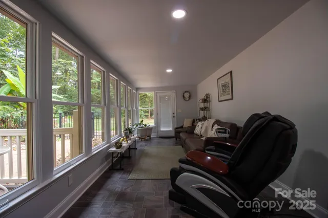 a view of a patio with table and chairs under an umbrella