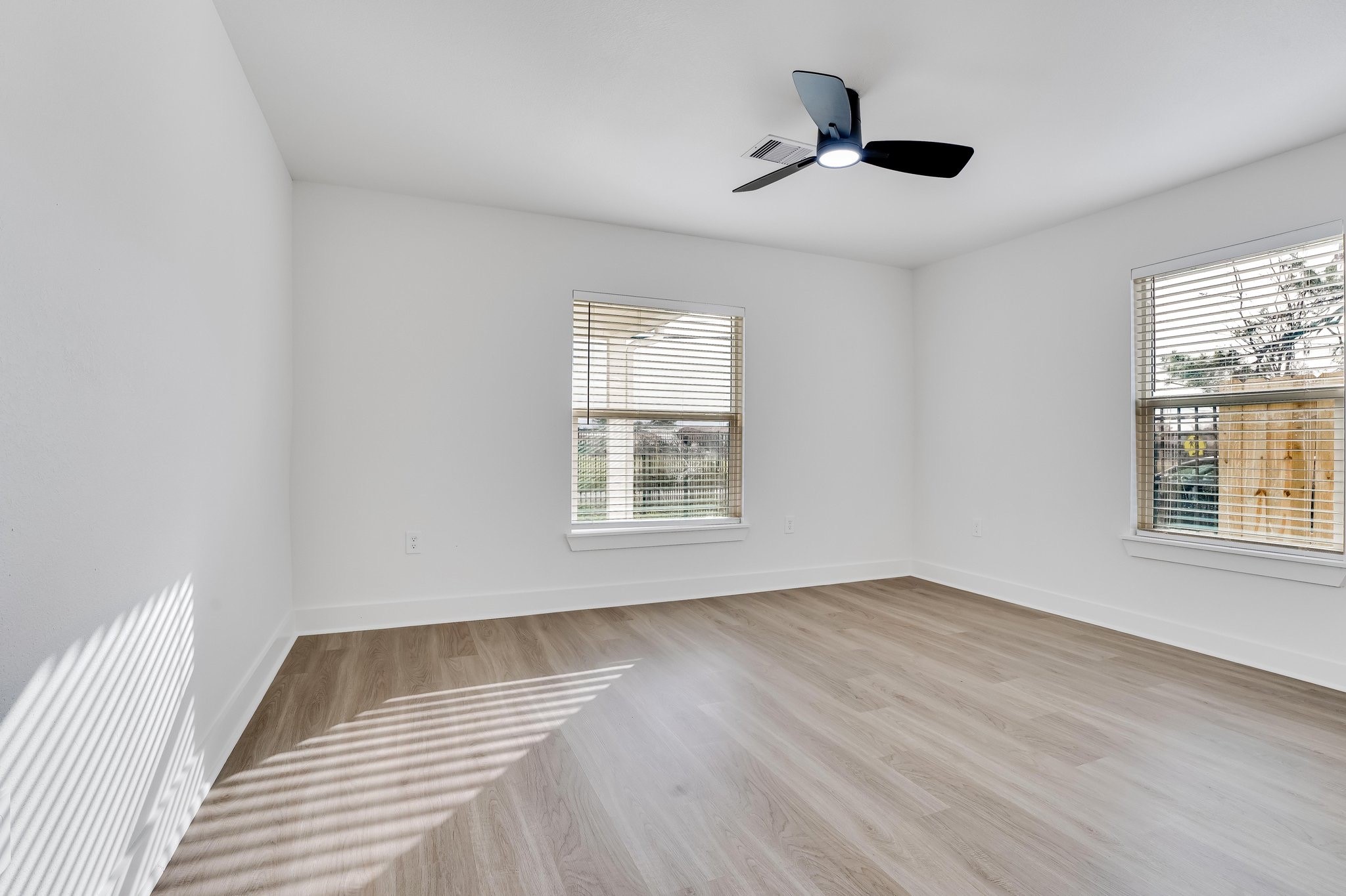 6123 Tuskegee Street Houston, TX 77091 - Photo 12 of 13 a view of an empty room with wooden floor and a window
