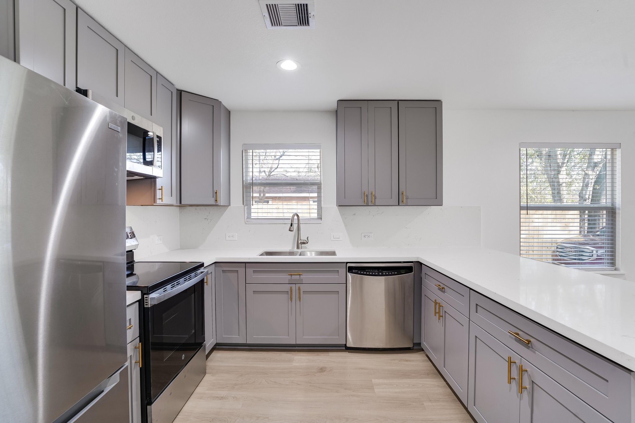 6123 Tuskegee Street Houston, TX 77091 - Photo 2 of 13 a kitchen with a sink stove and refrigerator