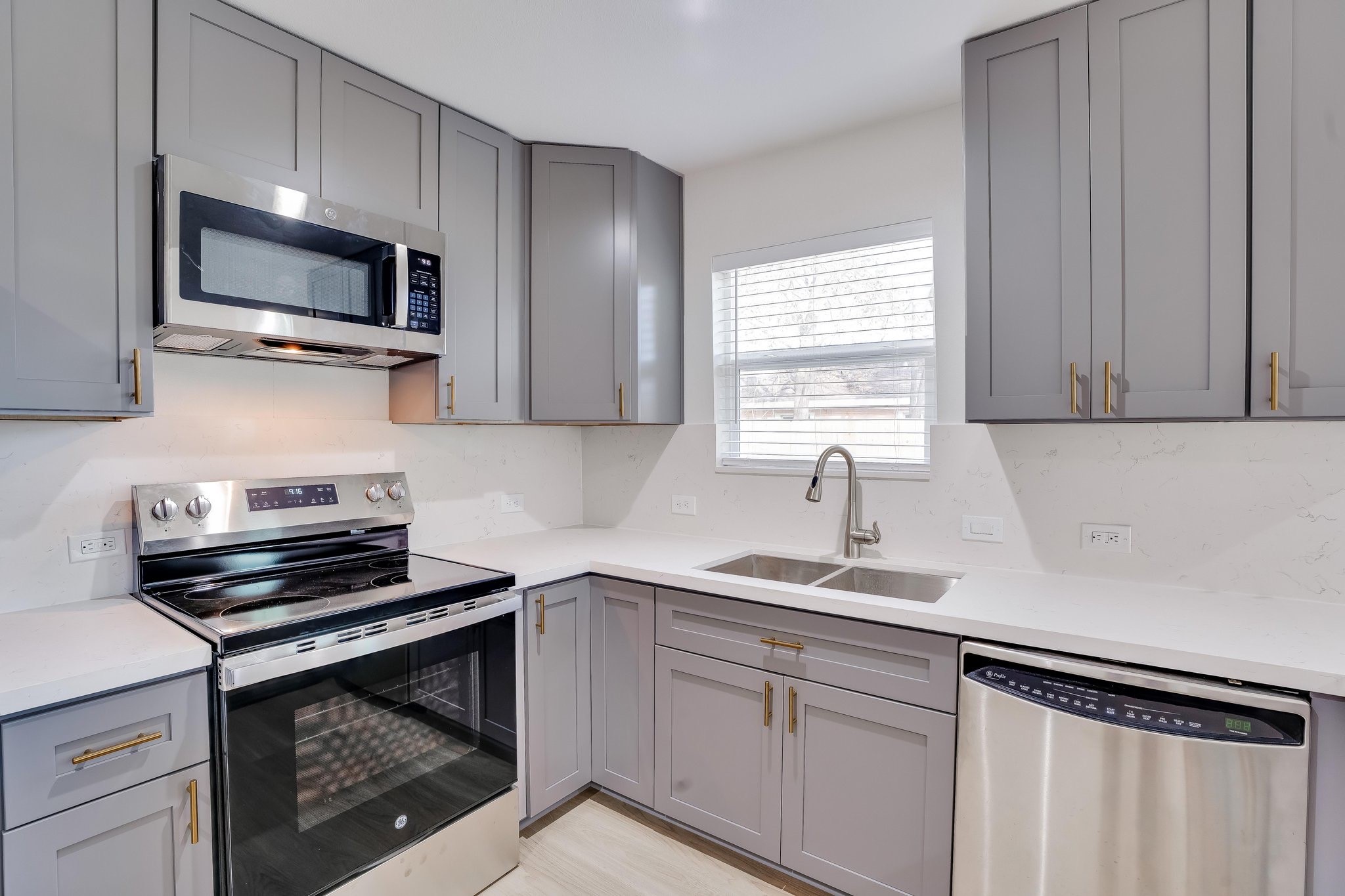 6123 Tuskegee Street Houston, TX 77091 - Photo 4 of 13 a kitchen with a sink stove and microwave