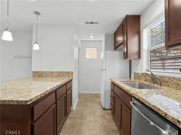 a bathroom with a granite countertop sink and a wooden floor
