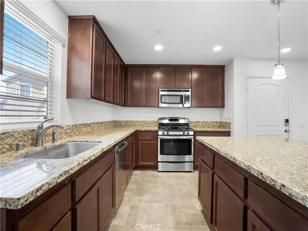 a kitchen with a sink stove top oven and microwave