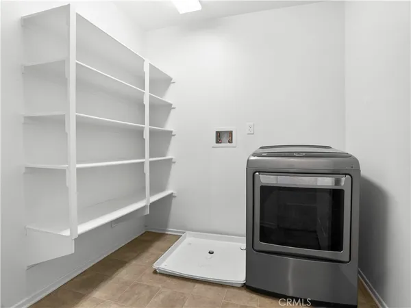 an empty room with closet and windows