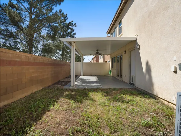 a porch with a table and chairs in front of it