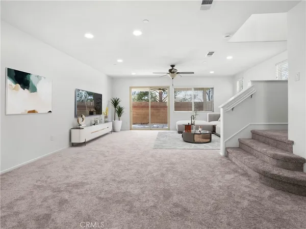 a view of a livingroom with furniture a fireplace and window
