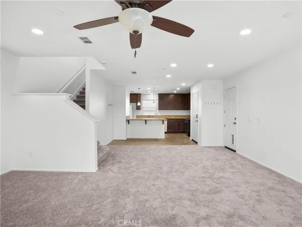 an empty room with a kitchen and a sink