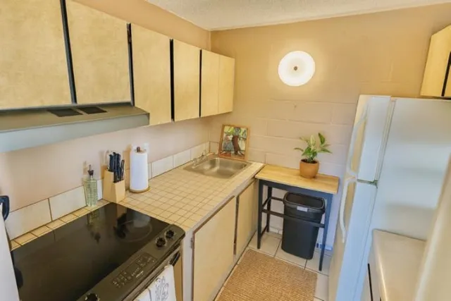 a kitchen with a sink and a refrigerator