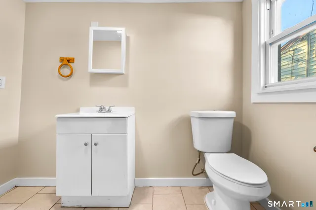 a white toilet sitting next to a bathroom sink