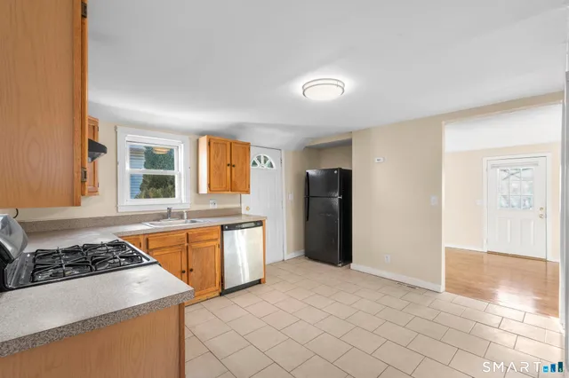 a kitchen with stainless steel appliances granite countertop a stove a refrigerator and a stove
