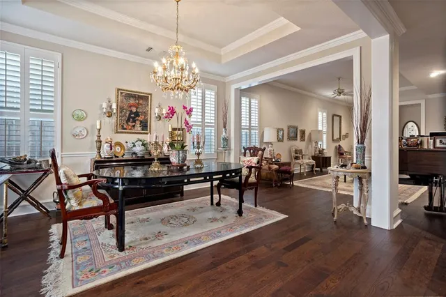 a living room with furniture or chandelier and a wooden floor