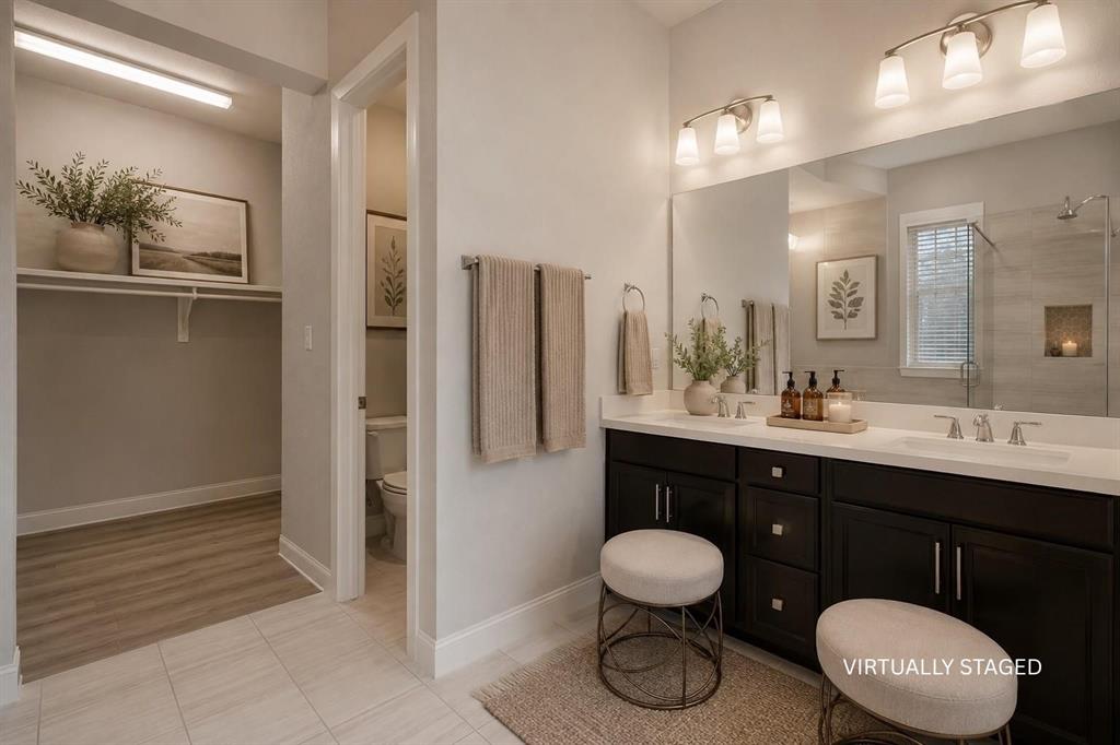 3721 Prickly Pear Road Little Elm, TX 75068 - Photo 18 of 21 Bathroom featuring a double vanity with dark wood-finish cabinetry, white countertops, and dual undermount sinks
