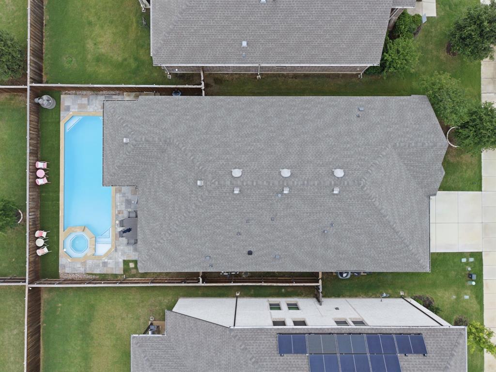 3721 Prickly Pear Road Little Elm, TX 75068 - Photo 21 of 21 Private backyard featuring a rectangular swimming pool with integrated spa, stone coping, and concrete patio