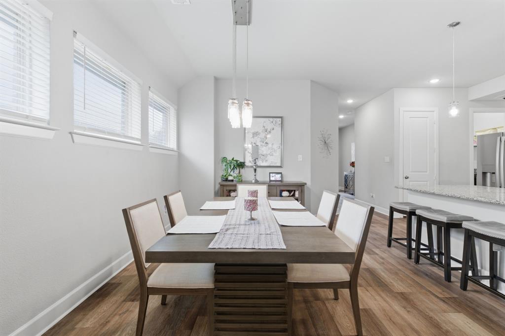 3721 Prickly Pear Road Little Elm, TX 75068 - Photo 7 of 21 Dining area featuring wood-finish flooring, recessed lighting, and a linear pendant light fixture
