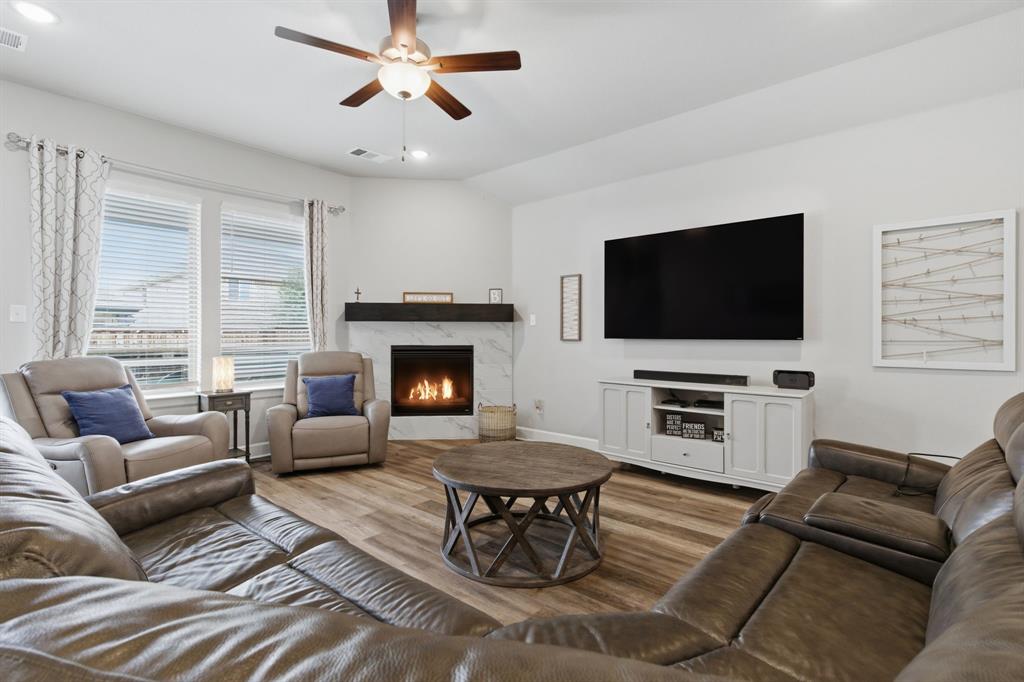 3721 Prickly Pear Road Little Elm, TX 75068 - Photo 10 of 21 Living area featuring wood-finish flooring and a ceiling fan with integrated lighting
