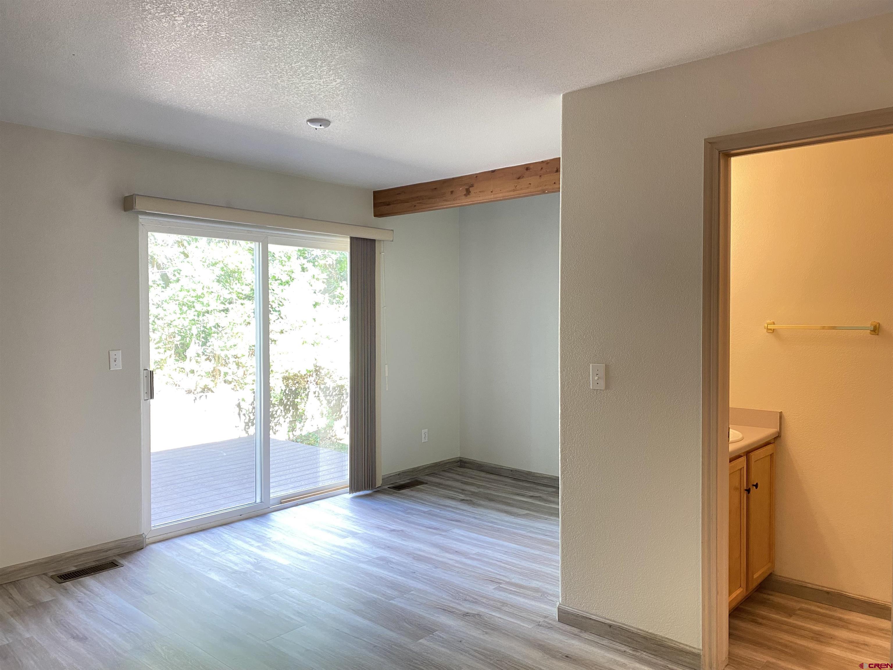 33 Sunridge Lane Durango, CO 81301 - Photo 12 of 37 a view of an empty room with wooden floor and a window