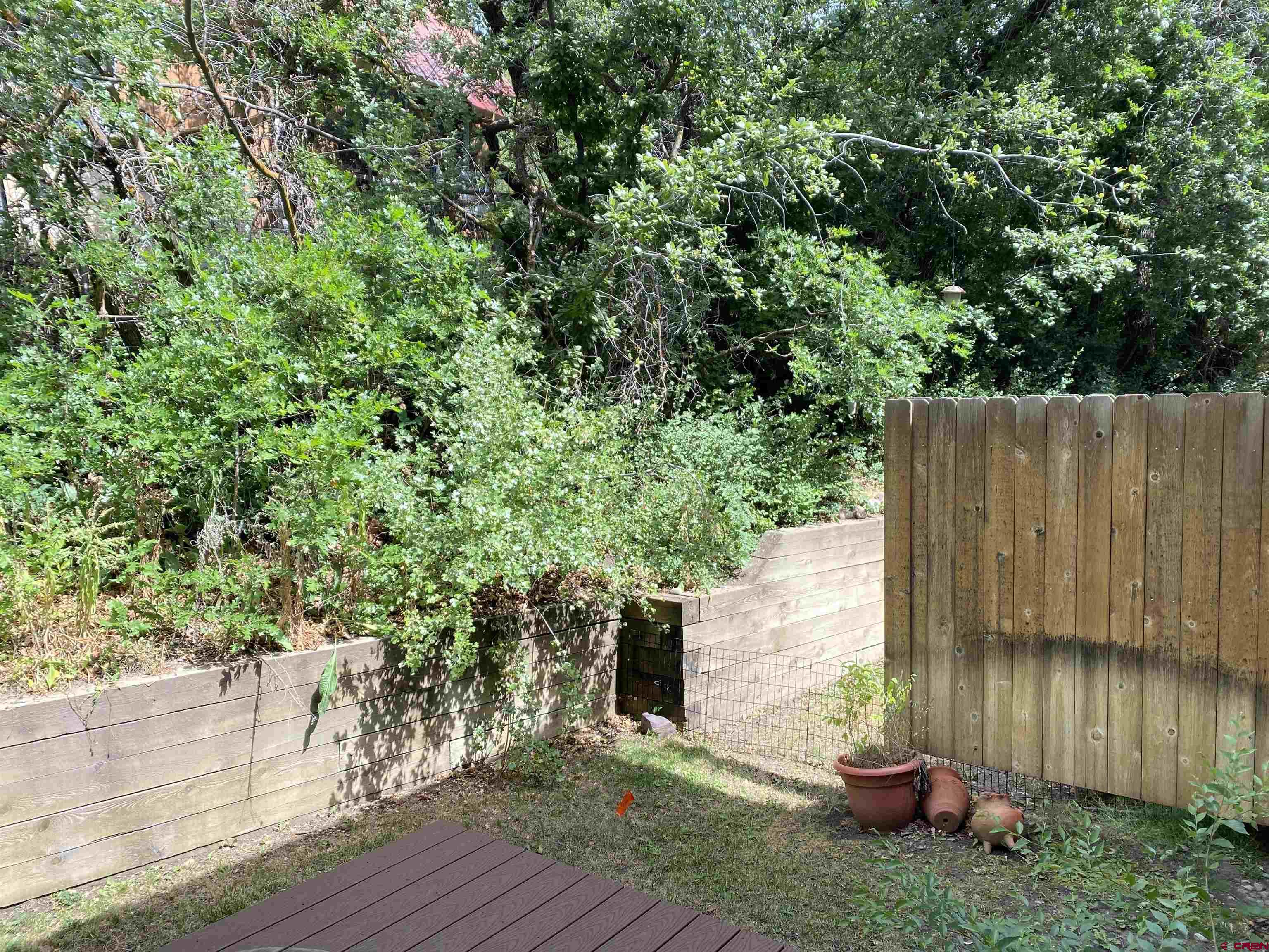 33 Sunridge Lane Durango, CO 81301 - Photo 34 of 37 a view of a backyard with plants and a bench